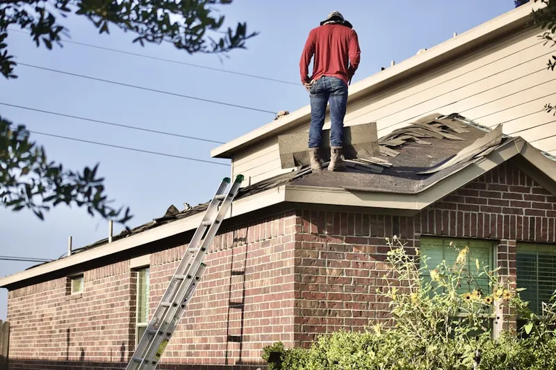 Professional roofer working on a residential roof in Churchill Farms
